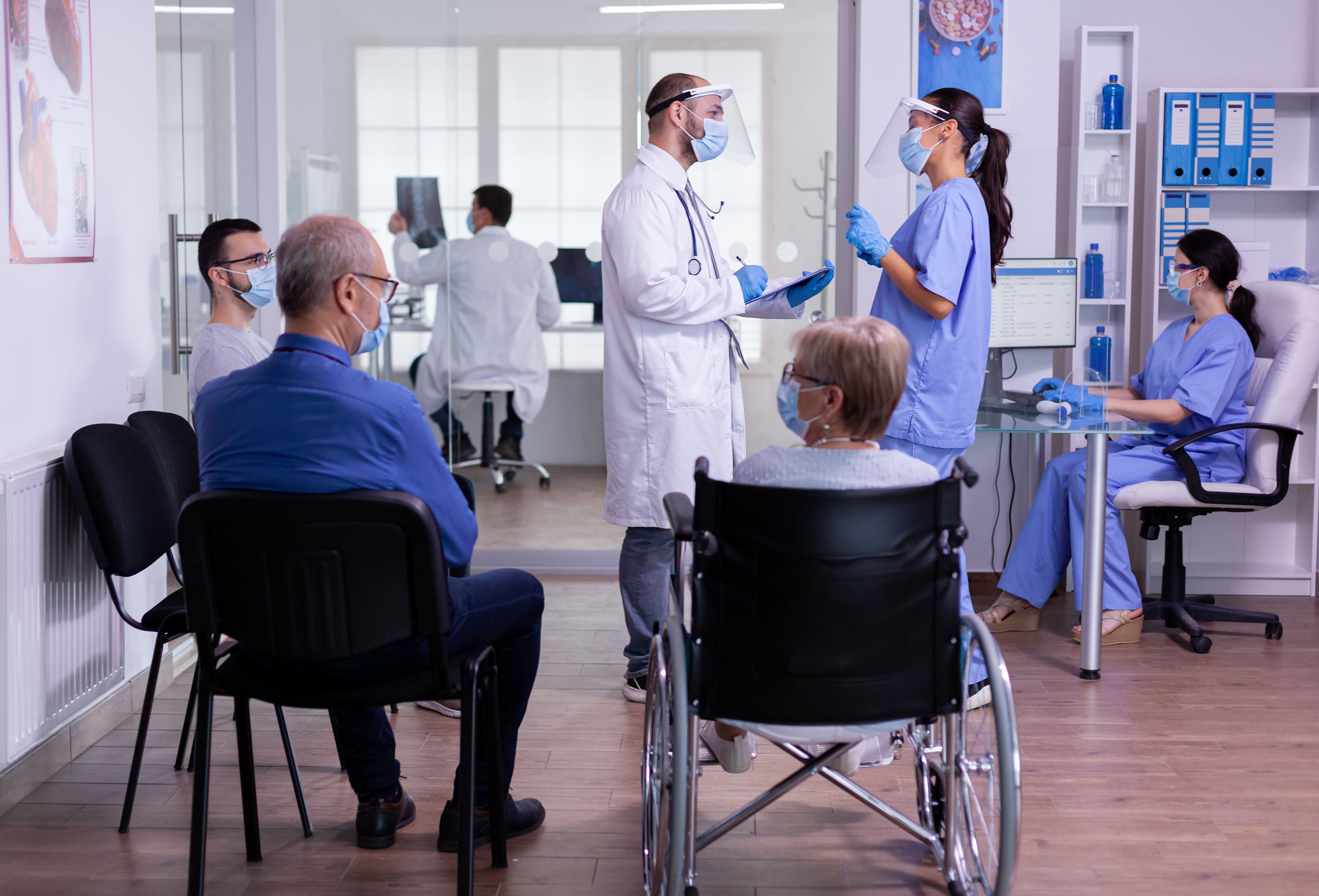 Patients and staff in healthcare waiting area