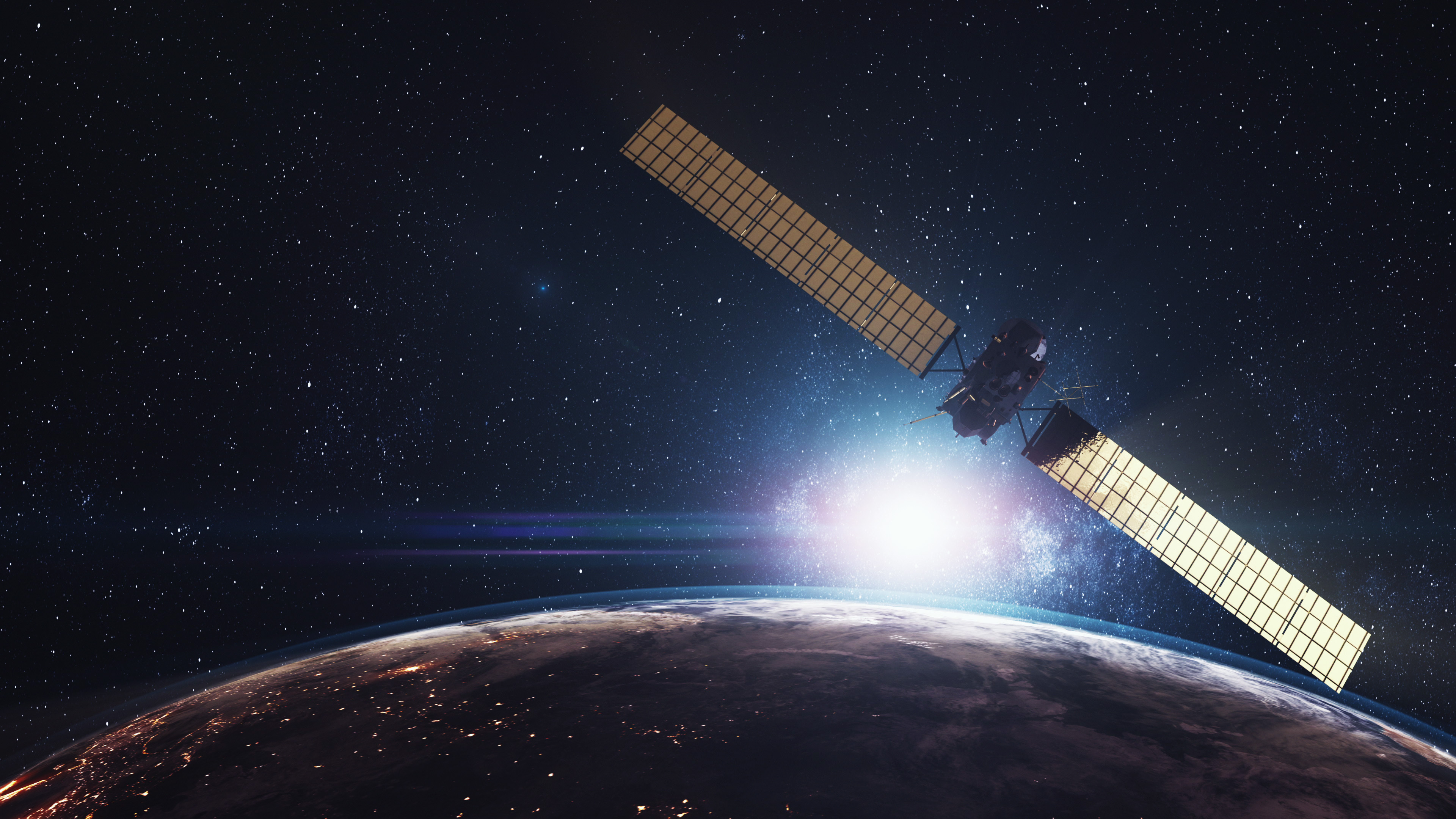 Satellite orbiting above Earth with stars in the background.
