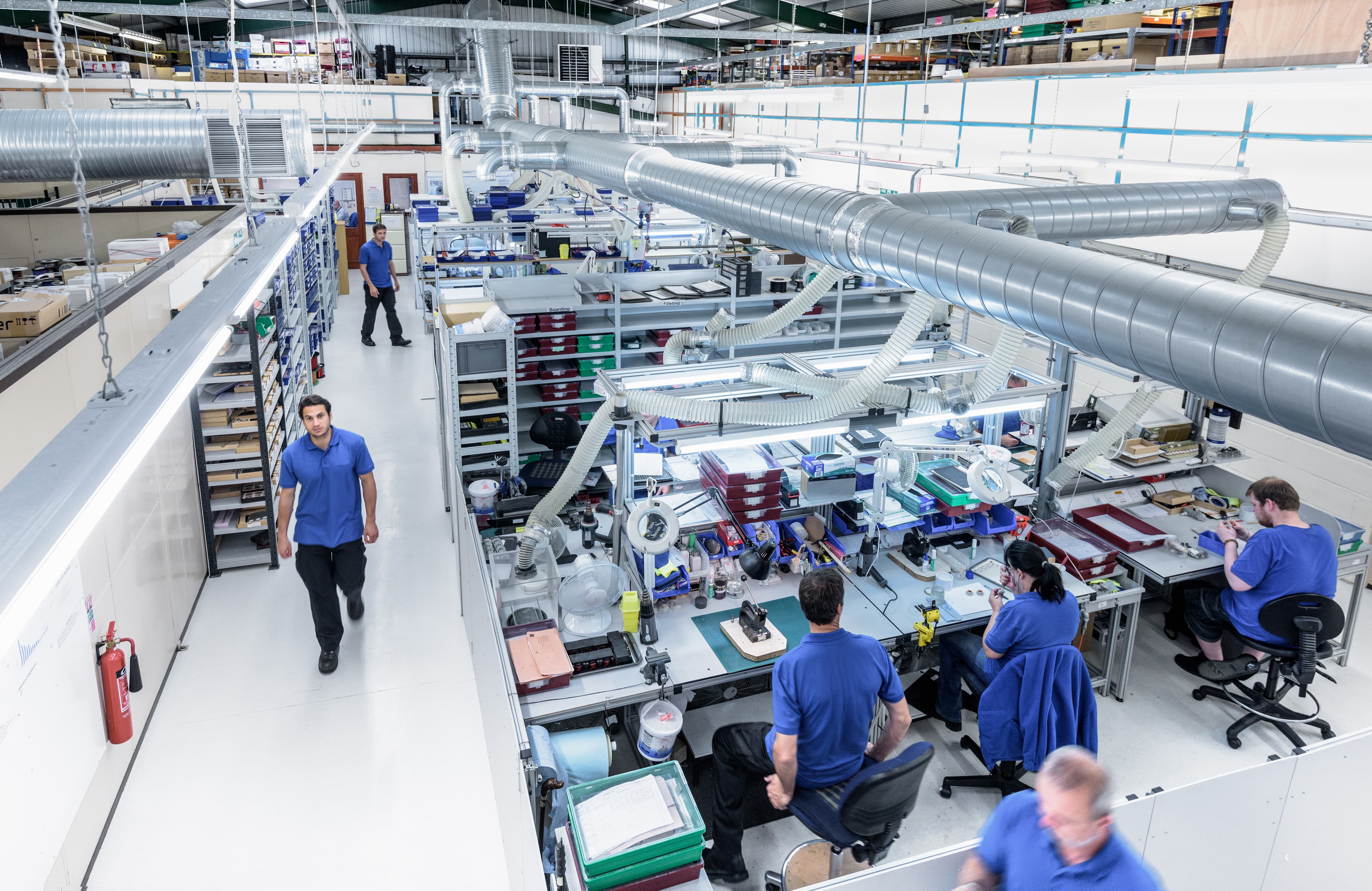 Industrial workers collaborating on production line