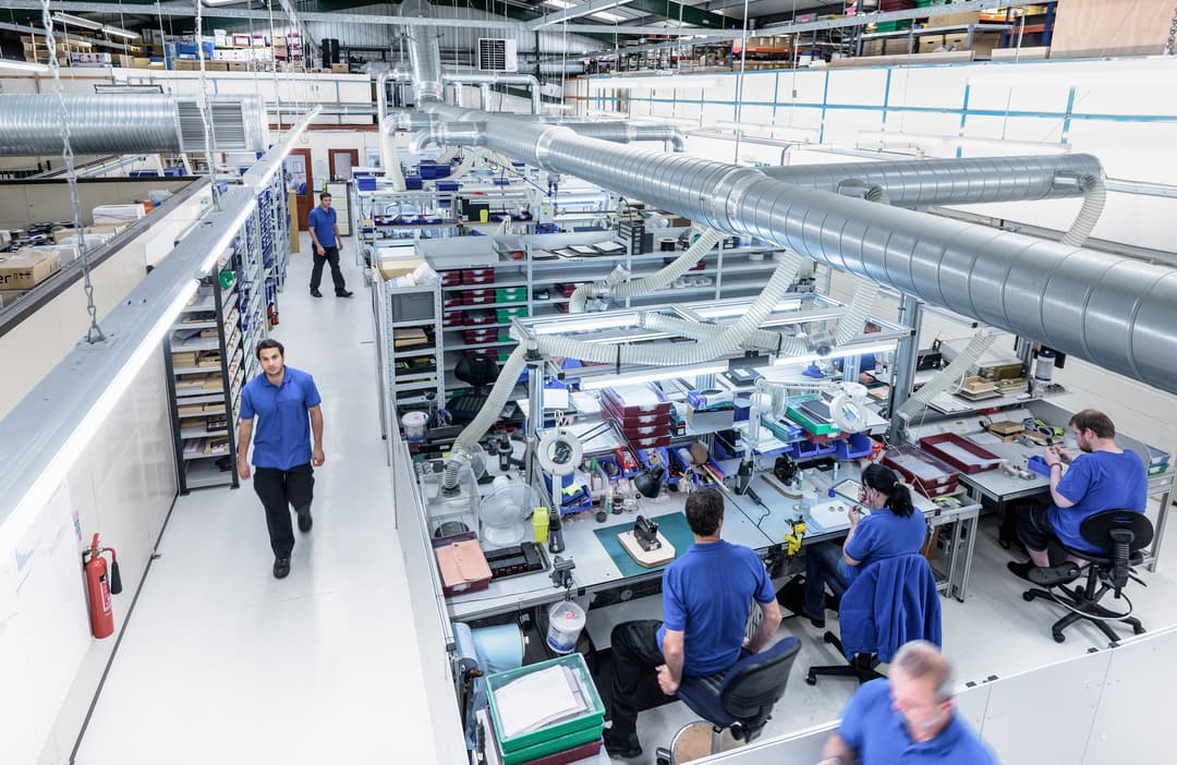 Industrial workers collaborating on production line