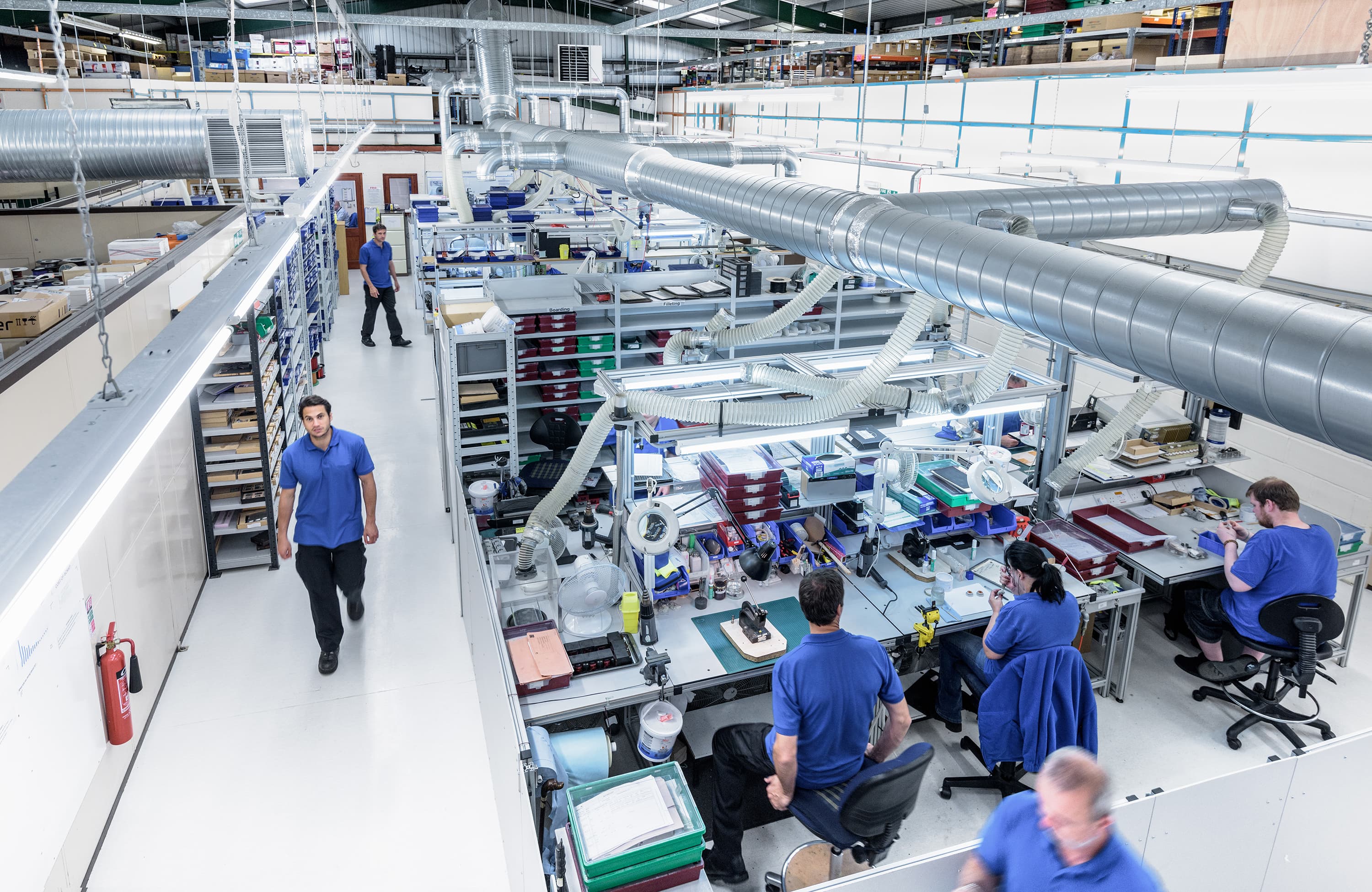Industrial workers collaborating on production line