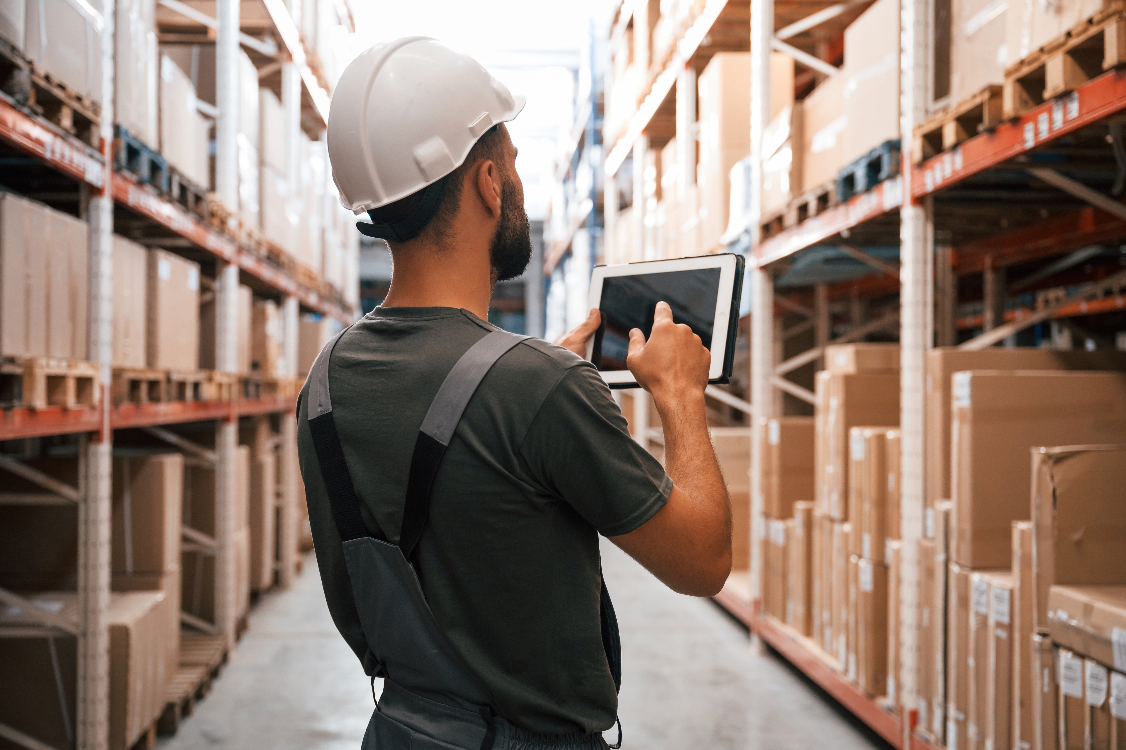 Warehouse worker using asset tracking tablet